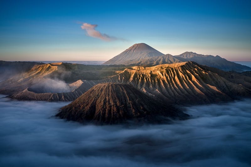 A view of a mountain covered in clouds